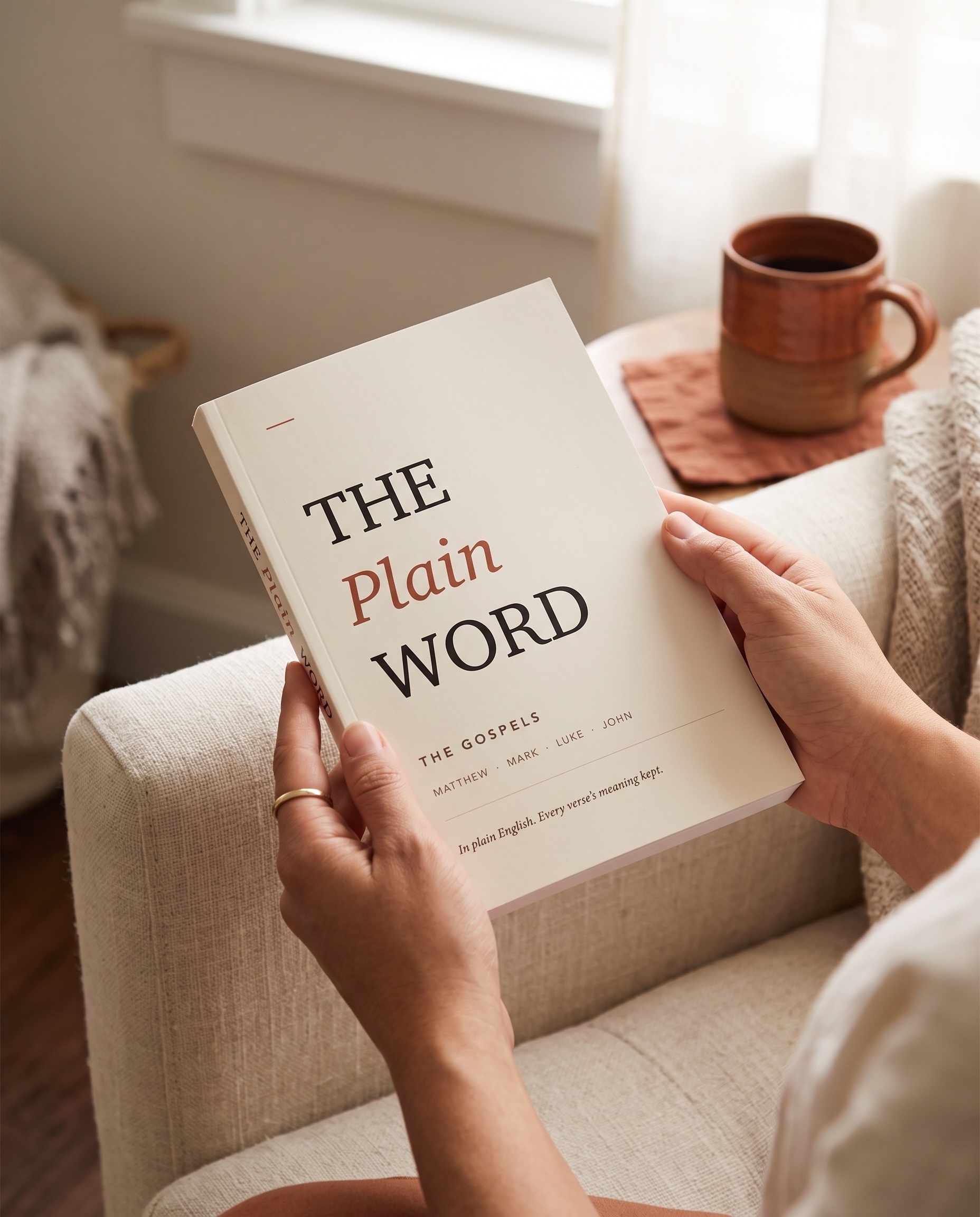 The Plain Word paperback held in a reader's hands in morning light