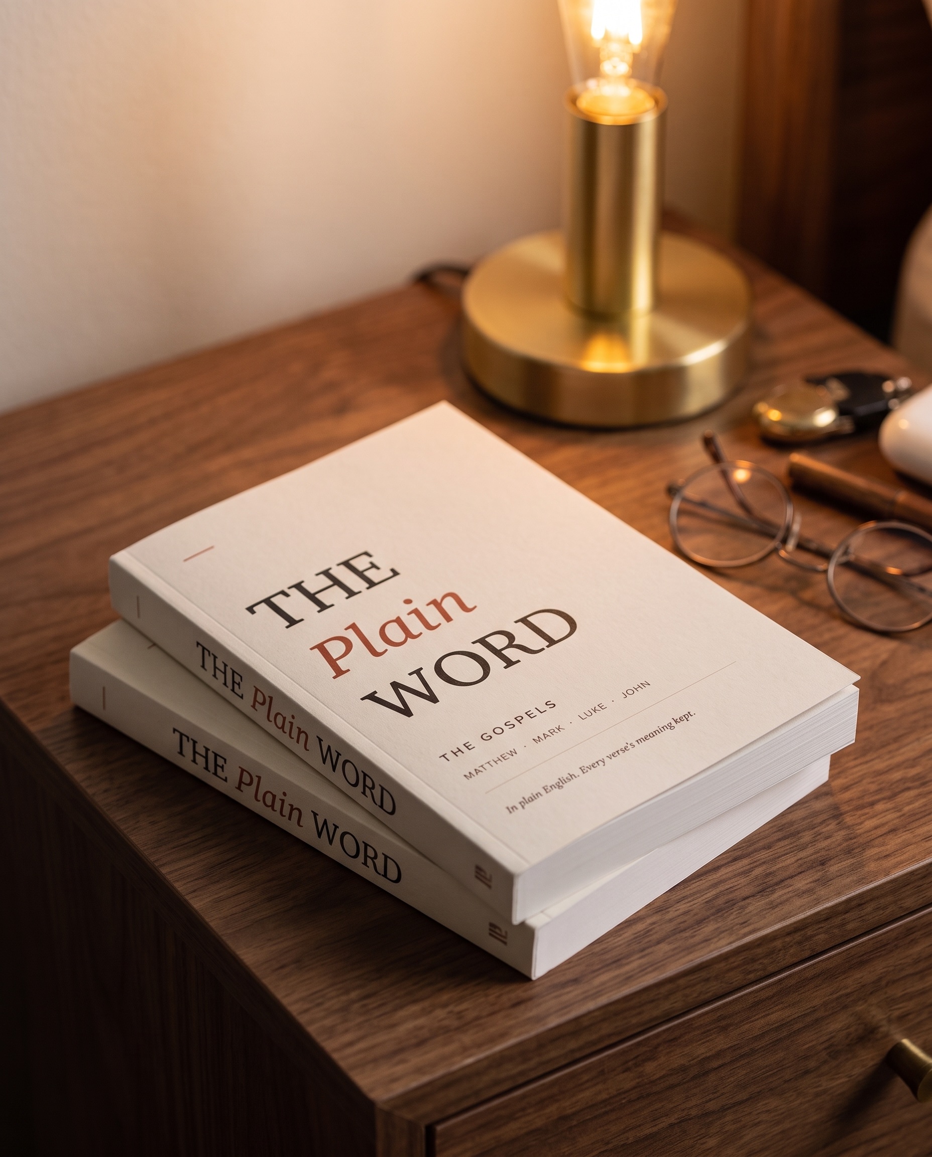 Two copies of The Plain Word stacked on a nightstand